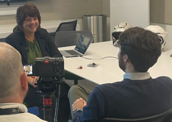 Dr. Kristy Arbogast is interviewed at a conference table by a reporter from the Philadelphia Inquirer. 
