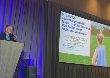 Matthew Grady presents at PRISM conference at podium